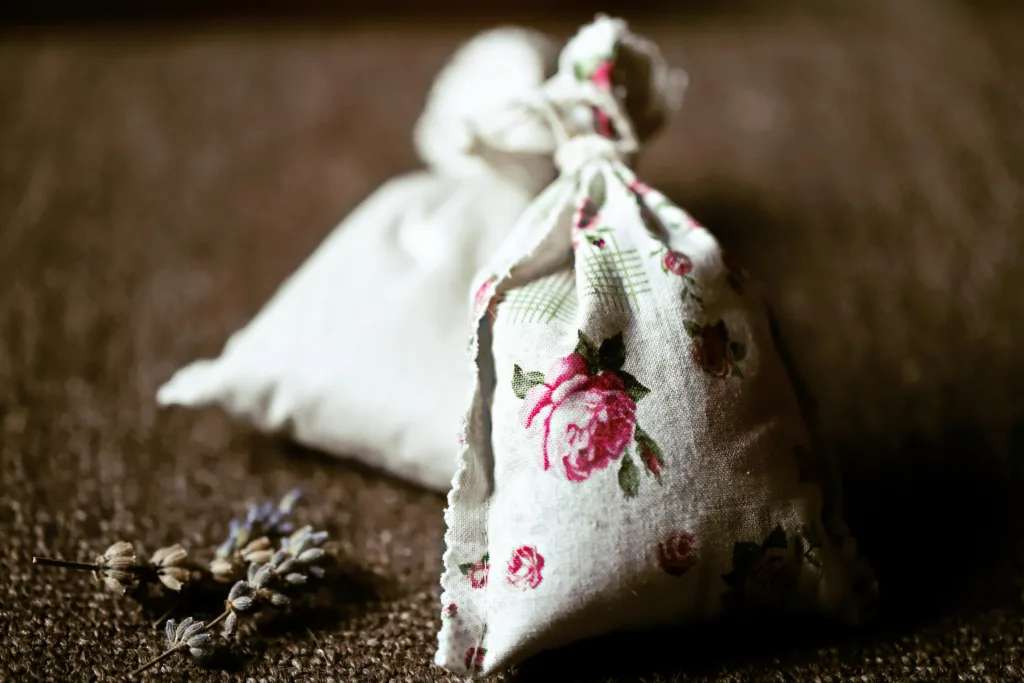 Handcrafted floral lavender sachet on textured surface perfect for aromatic therapy and decoration.